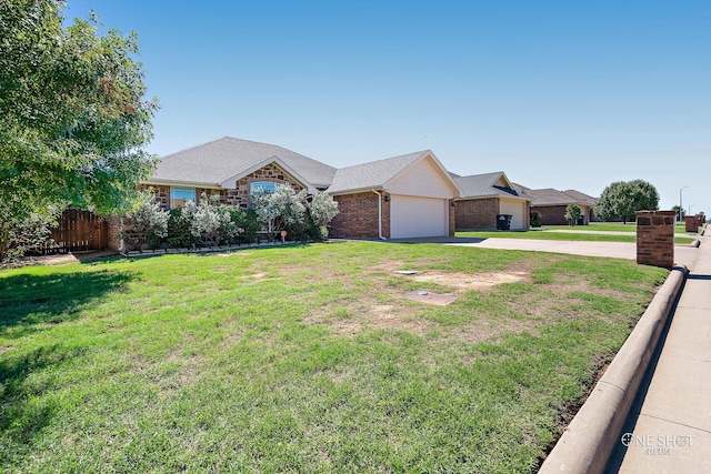 ranch-style home featuring a front yard and a garage