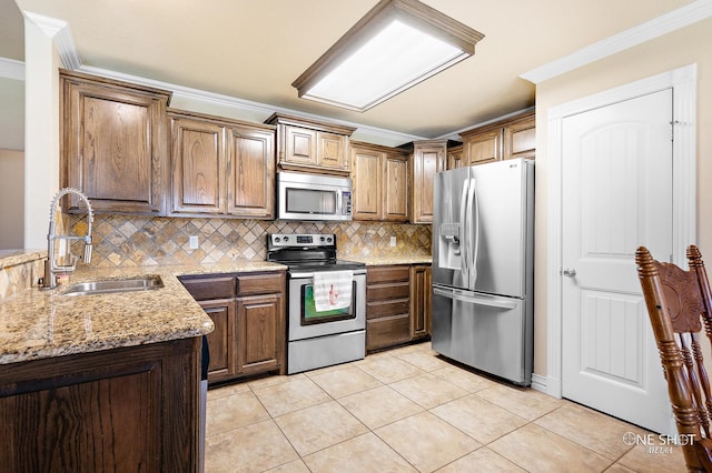 kitchen with appliances with stainless steel finishes, tasteful backsplash, light tile patterned floors, ornamental molding, and sink