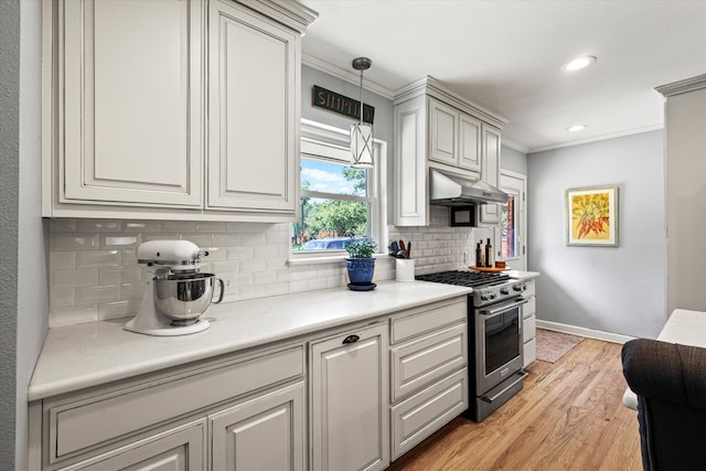 kitchen with light hardwood / wood-style floors, stainless steel range, tasteful backsplash, and crown molding