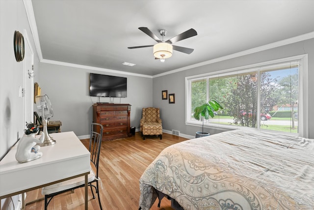 bedroom with light hardwood / wood-style floors, ceiling fan, and crown molding