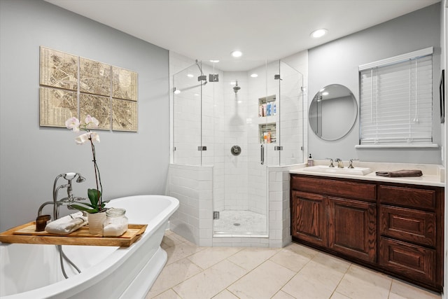 bathroom featuring vanity and separate shower and tub