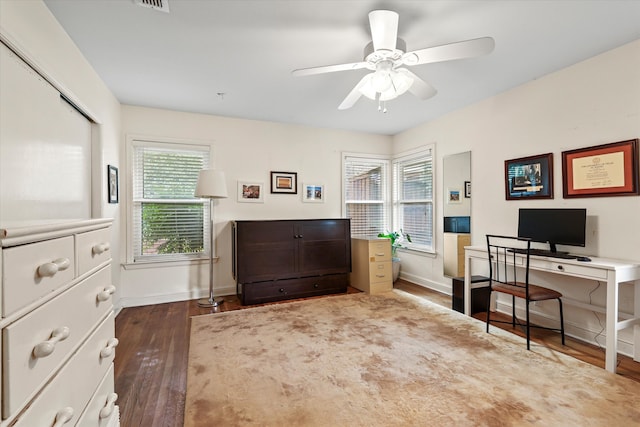 office area with a wealth of natural light, ceiling fan, and dark hardwood / wood-style flooring