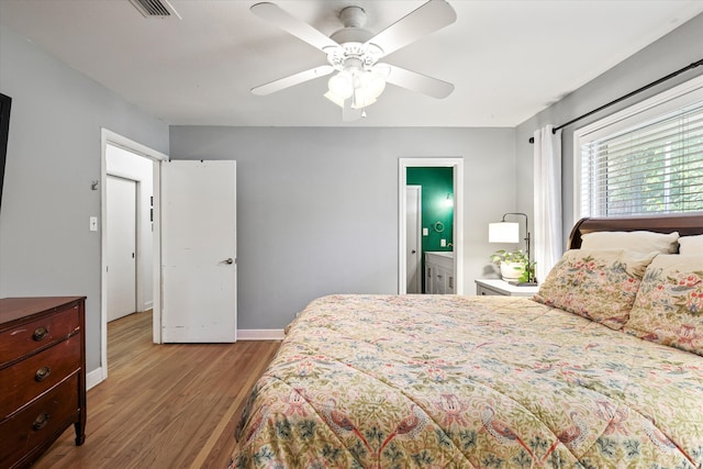 bedroom featuring ceiling fan, hardwood / wood-style flooring, and ensuite bathroom