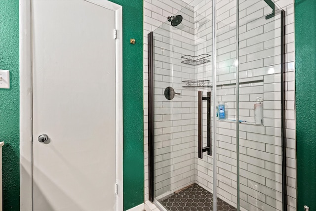 bathroom with a shower with door