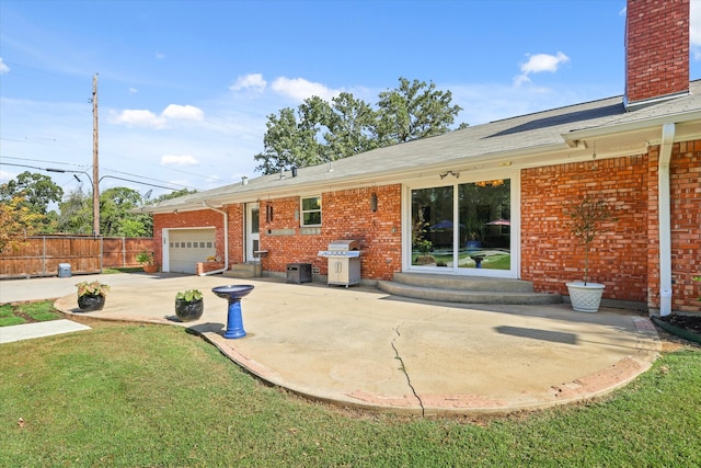 exterior space featuring a lawn, a patio, and a garage