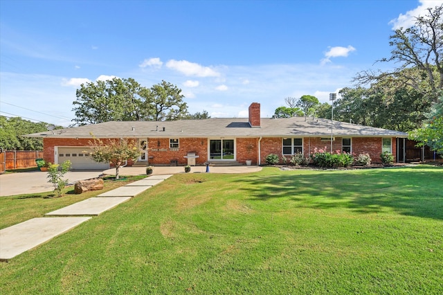 single story home with a garage and a front lawn