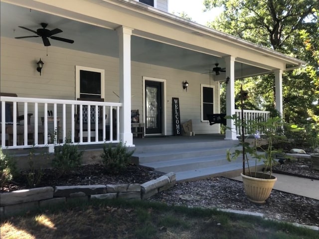 view of exterior entry with ceiling fan and covered porch