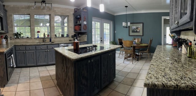 kitchen with hanging light fixtures, a kitchen island, french doors, black electric stovetop, and sink