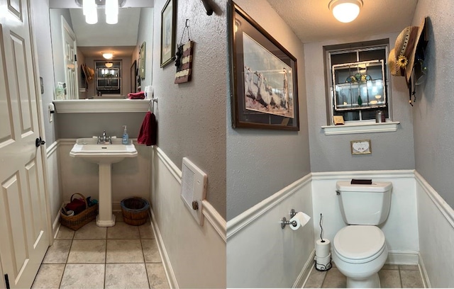 bathroom featuring toilet, sink, and tile patterned floors