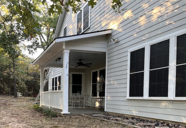 view of exterior entry featuring ceiling fan