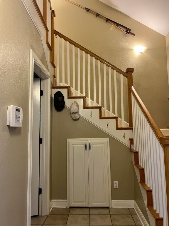 stairs featuring tile patterned flooring