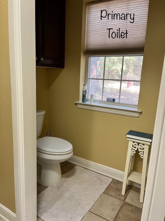 bathroom with tile patterned floors and toilet