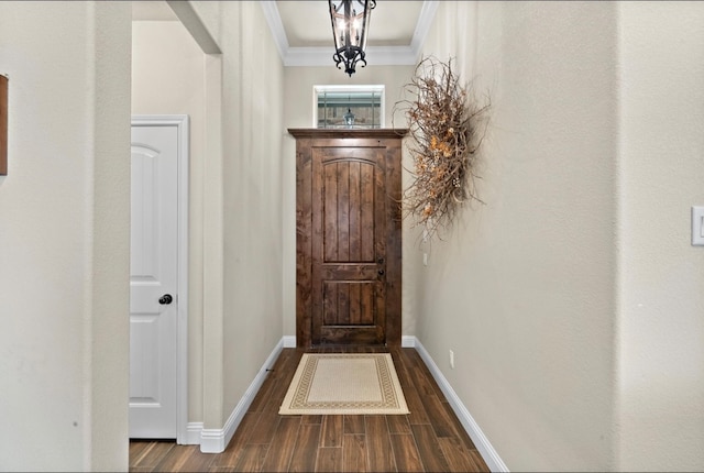 doorway featuring a chandelier, crown molding, and dark wood-type flooring