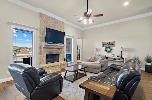 living room with crown molding, a fireplace, ceiling fan, and hardwood / wood-style flooring