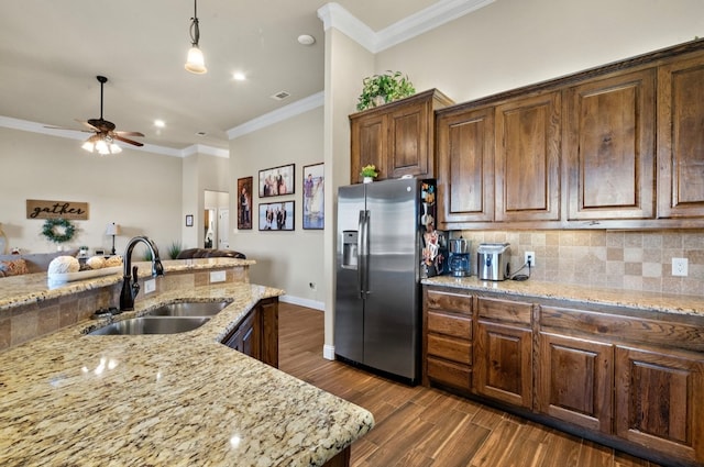 kitchen with decorative backsplash, stainless steel refrigerator with ice dispenser, dark hardwood / wood-style flooring, crown molding, and sink