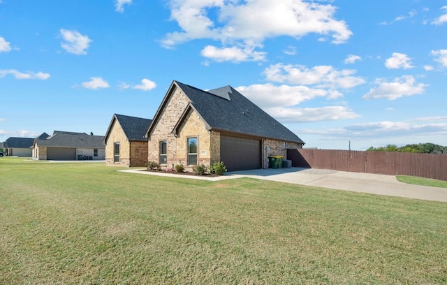 view of side of property with a lawn and a garage