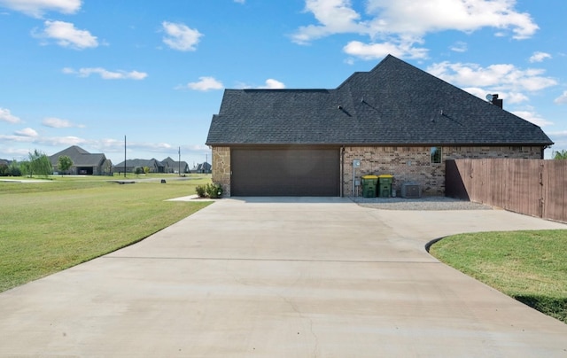 view of side of home featuring a yard and a garage