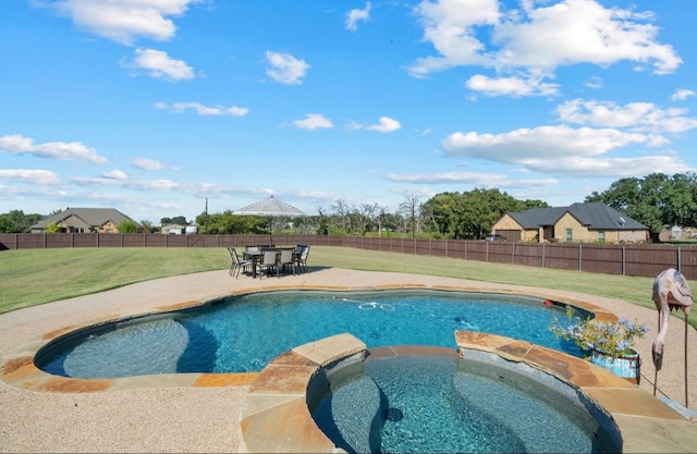 view of swimming pool with a yard, an in ground hot tub, and a patio