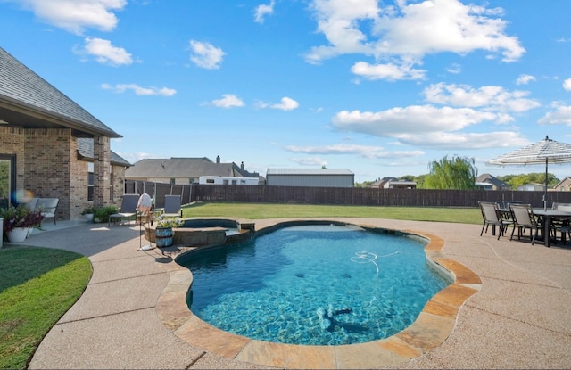 view of pool featuring a yard and a patio