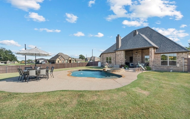 view of pool featuring an in ground hot tub, a yard, and a patio