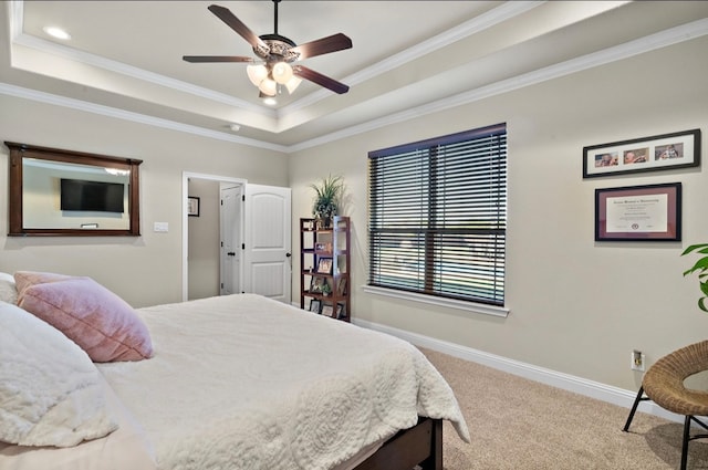 bedroom featuring carpet flooring, a raised ceiling, ceiling fan, and ornamental molding