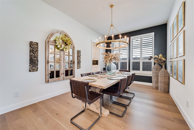 dining room featuring a chandelier and light wood-type flooring