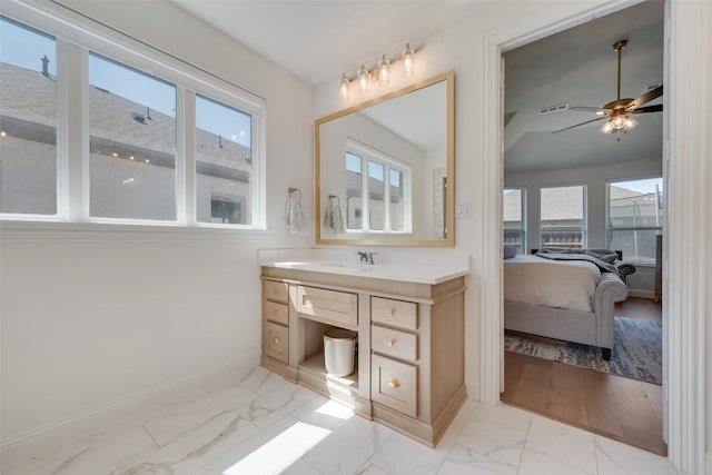 bathroom featuring ceiling fan, vanity, and a wealth of natural light