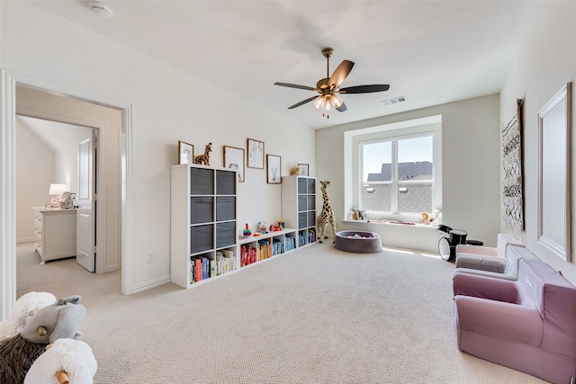 recreation room with ceiling fan and light colored carpet