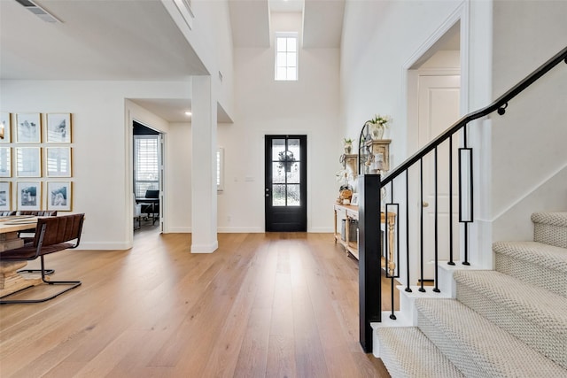 entrance foyer featuring a high ceiling and light hardwood / wood-style flooring