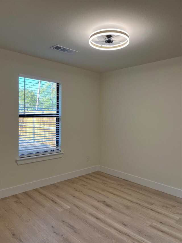 spare room with light hardwood / wood-style flooring