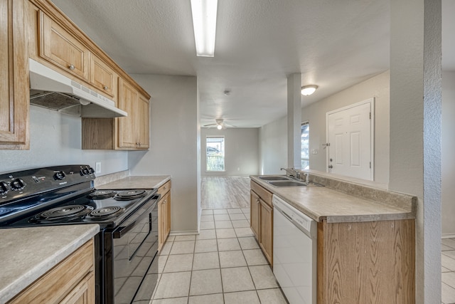 kitchen featuring light brown cabinets, light tile patterned flooring, sink, black electric range, and dishwasher