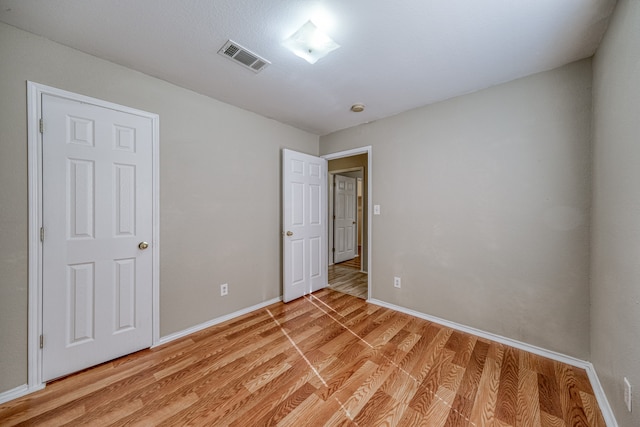 spare room featuring light hardwood / wood-style floors