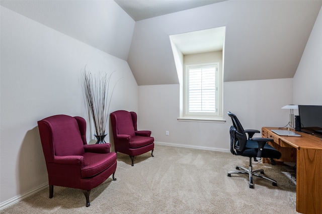 carpeted home office featuring lofted ceiling