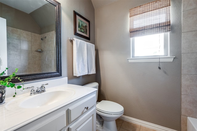 bathroom featuring vanity, tile patterned floors, and toilet