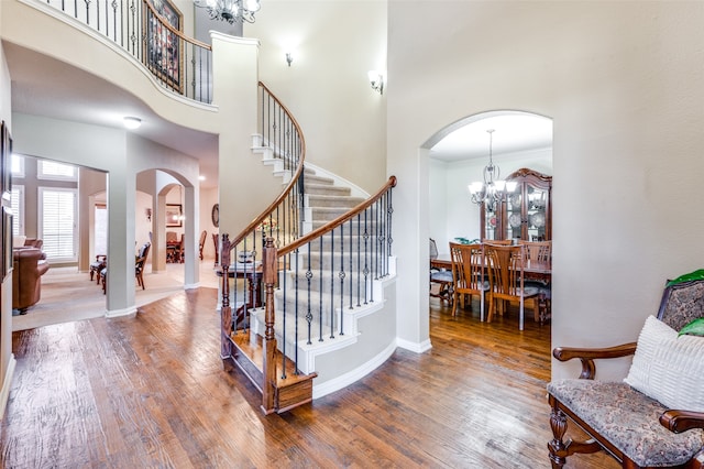 entrance foyer with a high ceiling, hardwood / wood-style flooring, and crown molding