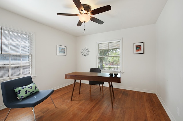 home office with wood-type flooring and ceiling fan