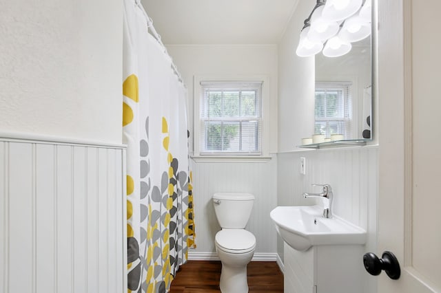 bathroom with a shower with shower curtain, toilet, vanity, hardwood / wood-style flooring, and ornamental molding