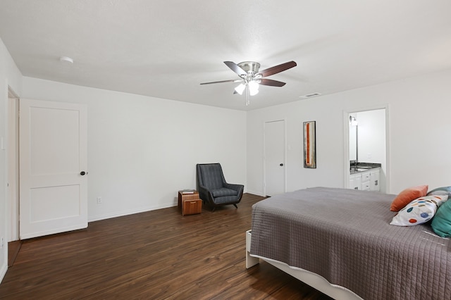 bedroom featuring dark wood-type flooring, ceiling fan, and ensuite bath