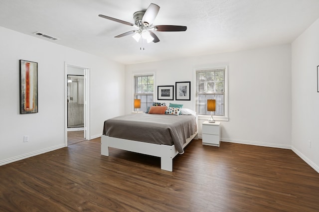 bedroom featuring dark hardwood / wood-style floors, ensuite bathroom, and ceiling fan