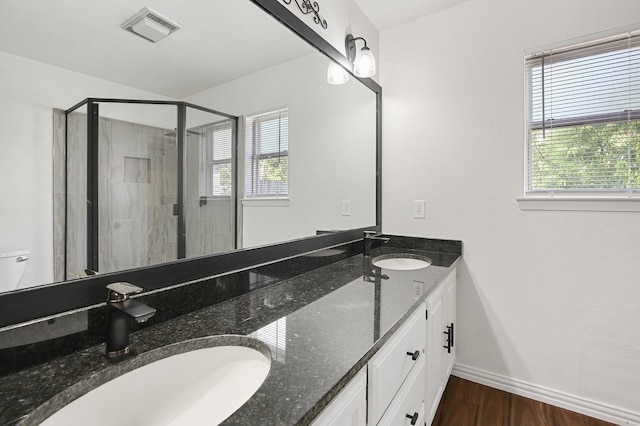 bathroom with vanity, a shower with shower door, and hardwood / wood-style floors