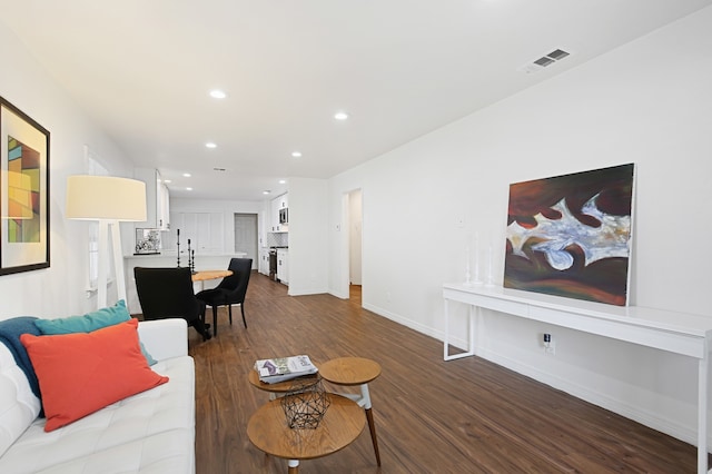 living room featuring dark wood-type flooring