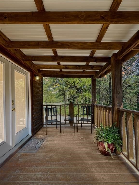 wooden terrace featuring covered porch