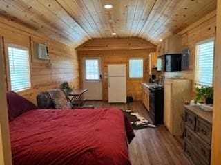 bedroom with wooden ceiling, white fridge, and vaulted ceiling