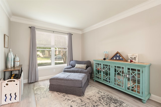 living area featuring ornamental molding and light wood-type flooring