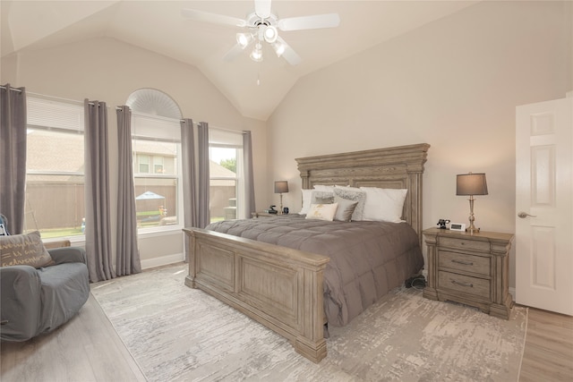 bedroom featuring lofted ceiling, light wood-type flooring, and ceiling fan