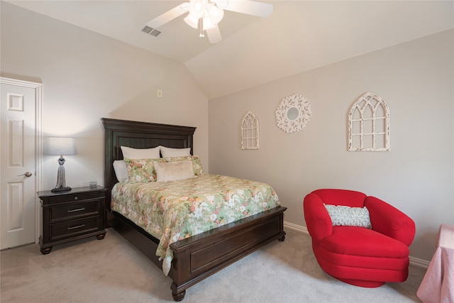 bedroom with ceiling fan, vaulted ceiling, and light colored carpet