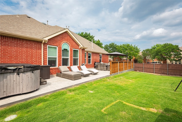 view of yard featuring a hot tub, outdoor lounge area, and a patio