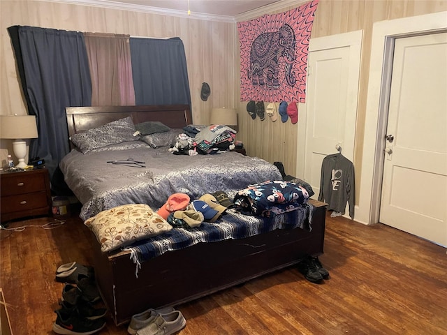 bedroom featuring ornamental molding and dark hardwood / wood-style floors