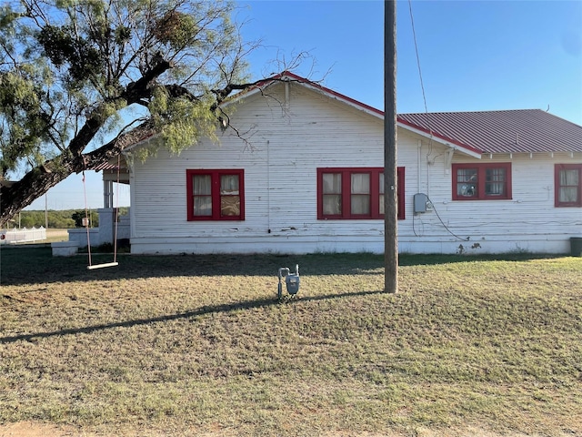 view of home's exterior with a lawn