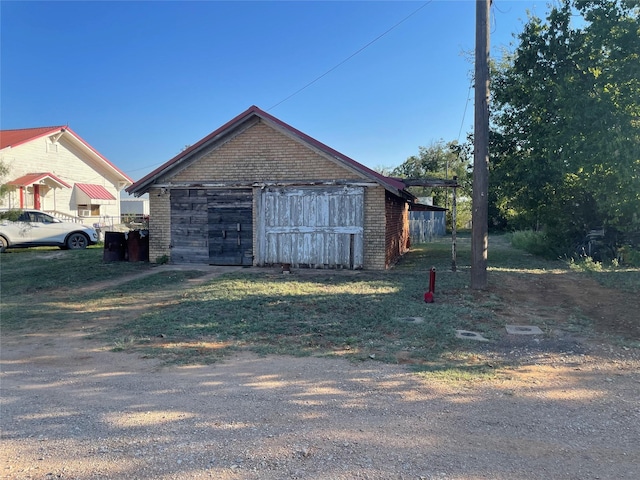 view of home's exterior with an outbuilding